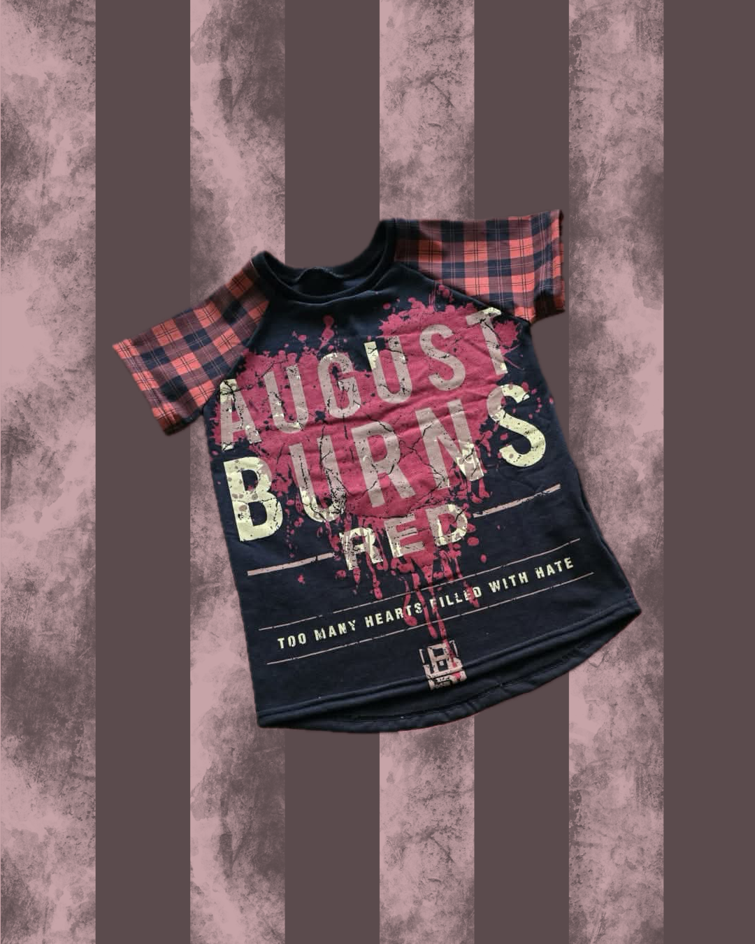 Black t-shirt with 'August Burns Red' text on a textured brown background