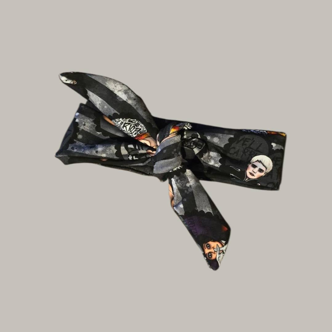 Decorative headband with a black and white pattern on a gray background