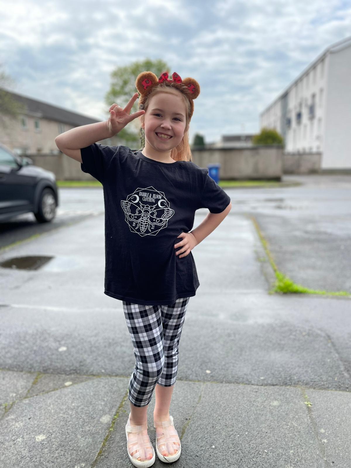 An Alt Originals customer wearing a handmade alternative capris & DTF top