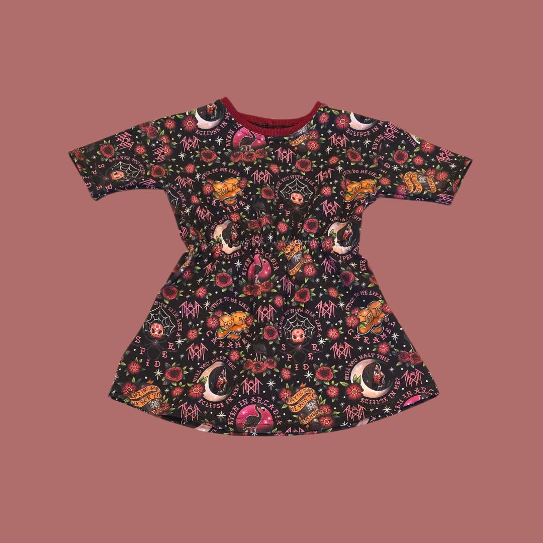 Children's dress with band-themed pattern on a brown background