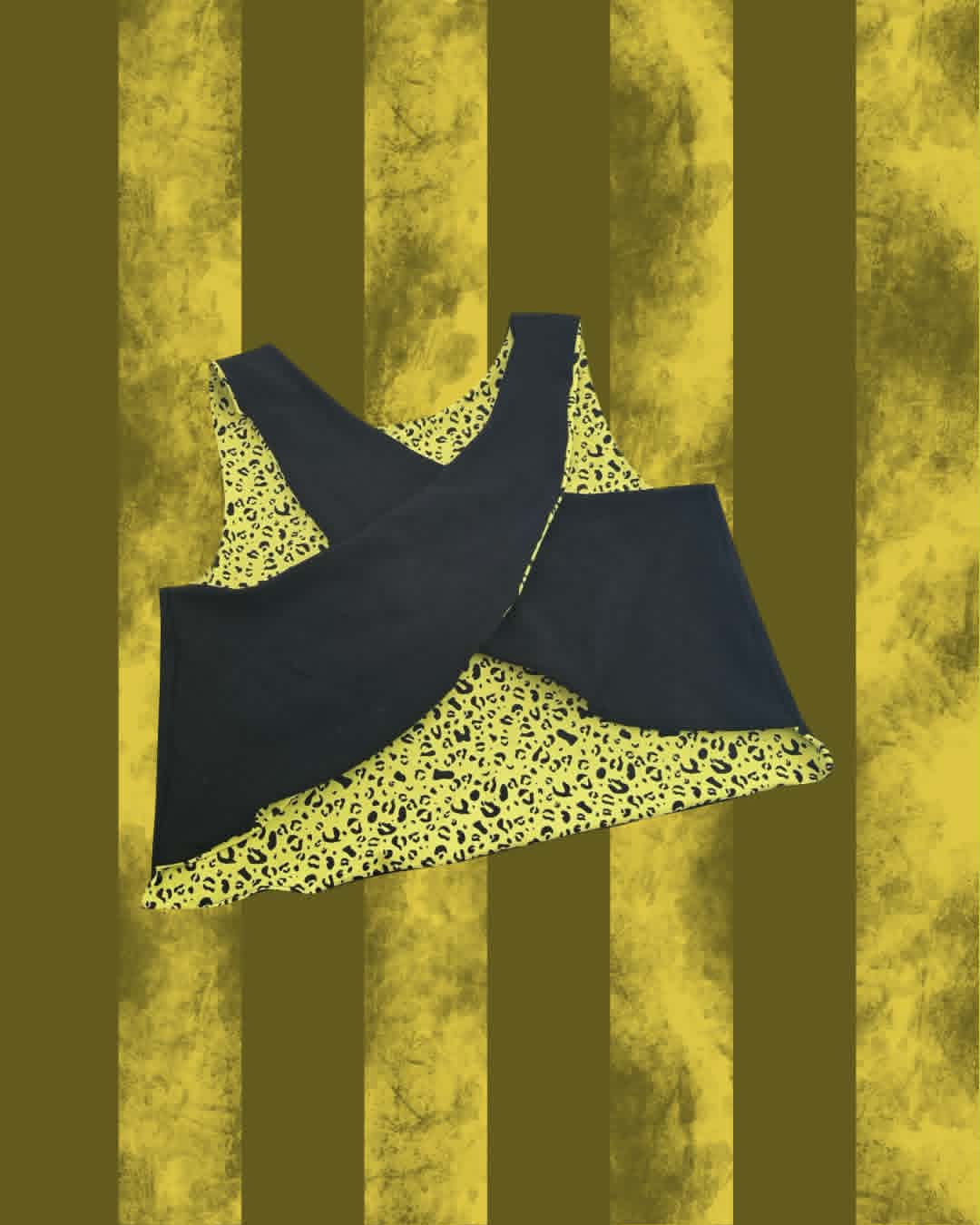 A sleeveless A Day to Remember top with a black overlay and a yellow leopard-print lining