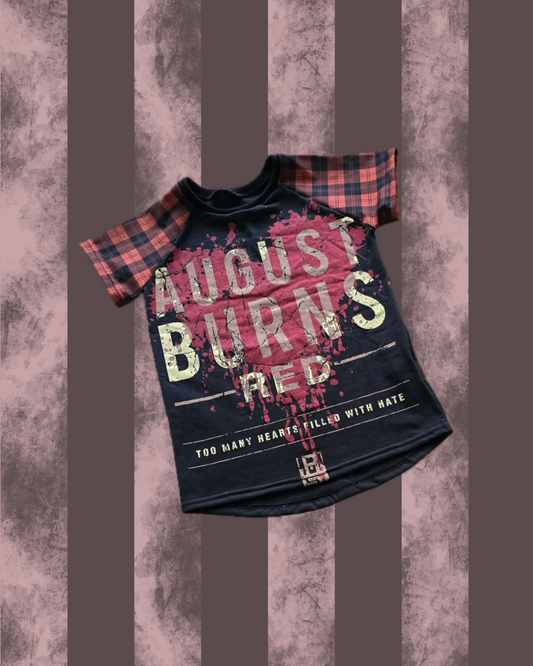 Black t-shirt with 'August Burns Red' text on a textured brown background