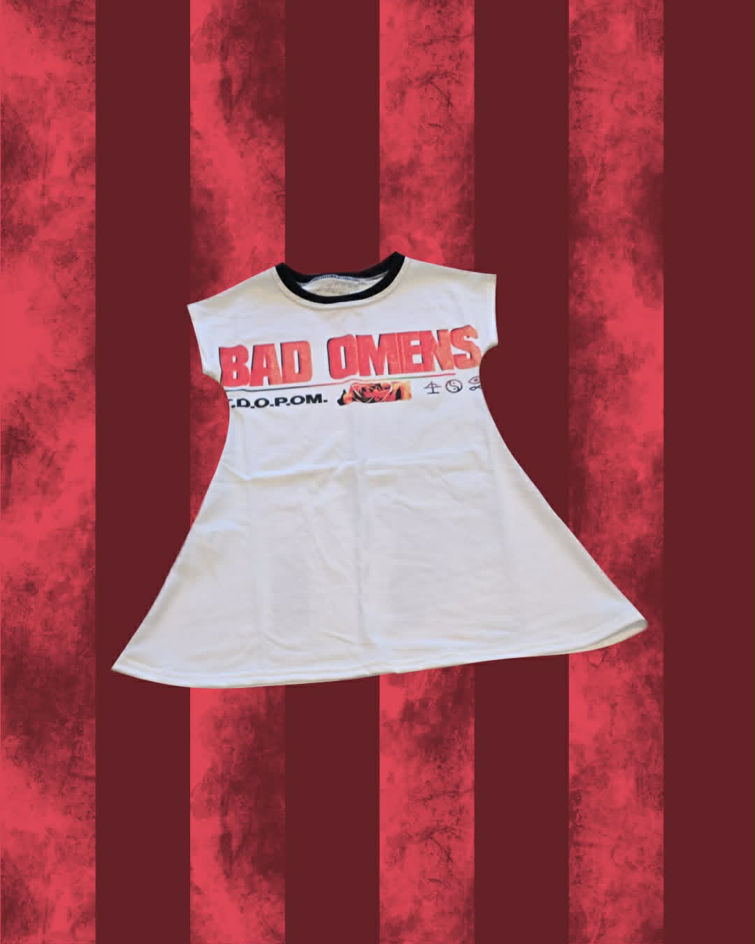 A white sleeveless ringer T-shirt dress featuring a black crew neck and a graphic print on the front that reads 'BAD OMENS' in red and black, with 'T.D.O.P.O.M"