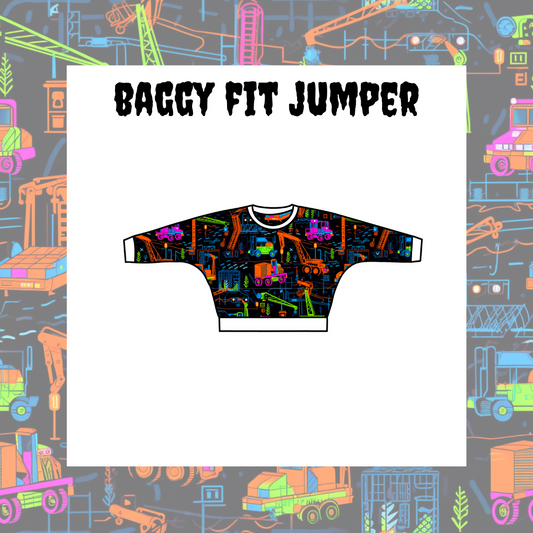 A colorful graphic t-shirt with a construction theme layout, titled 'BAGGY FIT JUMPER' on a background with various construction vehicles and designs.