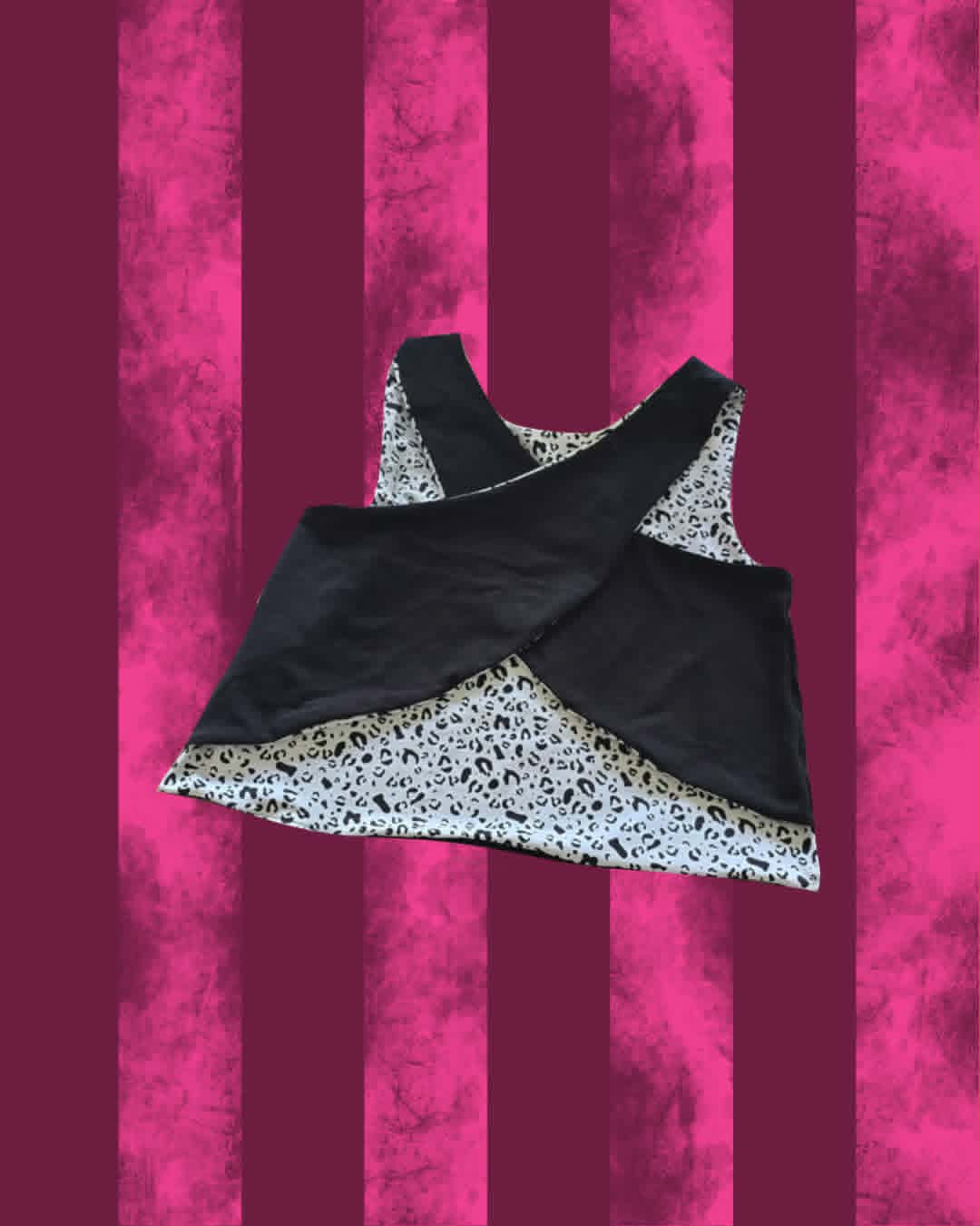 A sleeveless black cross back 'Bring Me the Horizon' top with a white and black patterned lining