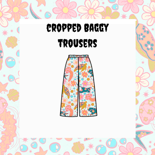 Illustration of cropped baggy trousers with a floral and colorful pattern, displayed against a floral patterned background.