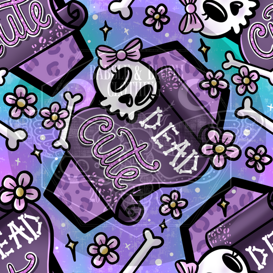 A pastel pink/purple repeating design featuring a coffin, skulls and flowers and reads "DEAD CUTE"