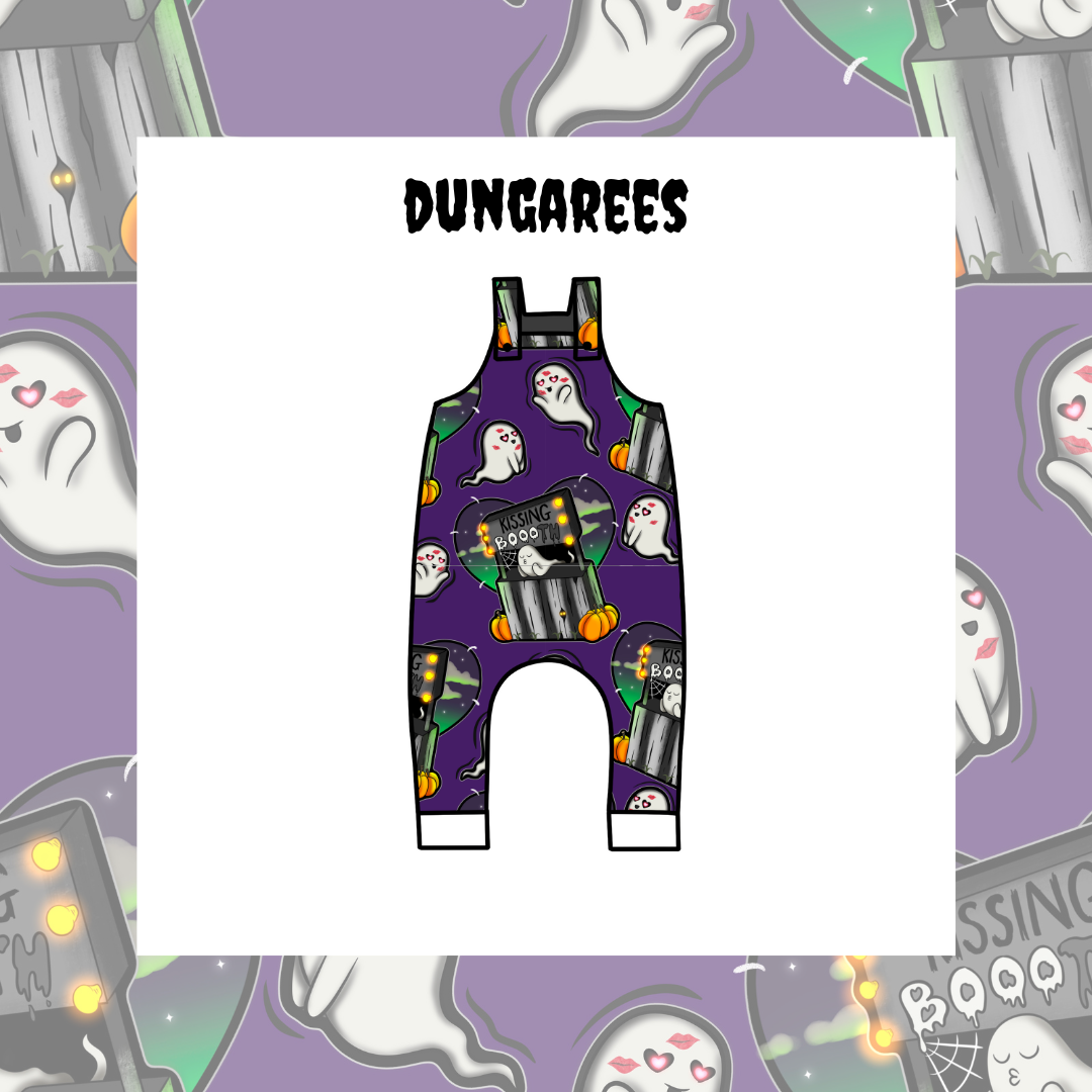 Kids' dungarees with a Halloween theme, featuring a purple background and decorated with ghosts, pumpkins, and the word 'BOO!'.
