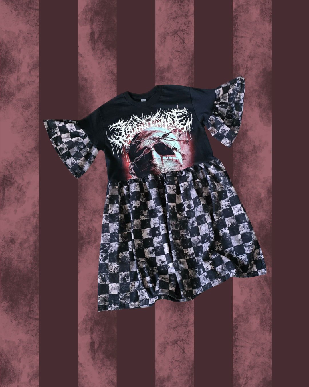 Black LORNA SHORE t-shirt with graphic design and checkered dress on a striped background