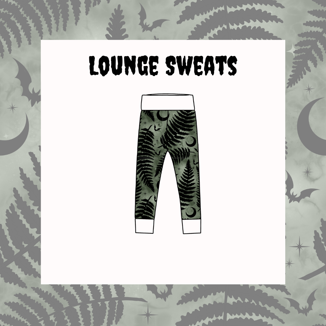Leggings with fern and bat pattern on a light gray background with moon and star designs.