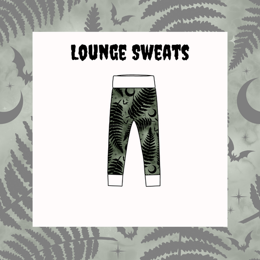 Leggings with fern and bat pattern on a light gray background with moon and star designs.