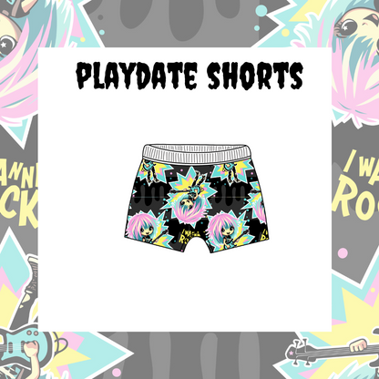 Children's playdate shorts with a colorful character and text design on a black background, displayed against a background with graphic elements.