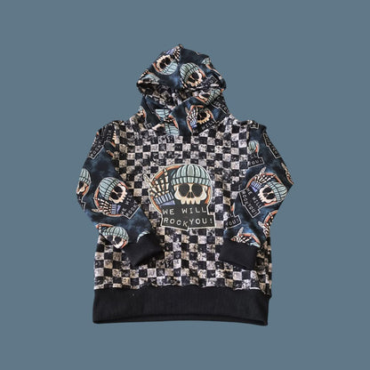 A hooded top with checkerboard body and printed WE WILL ROCK YOU