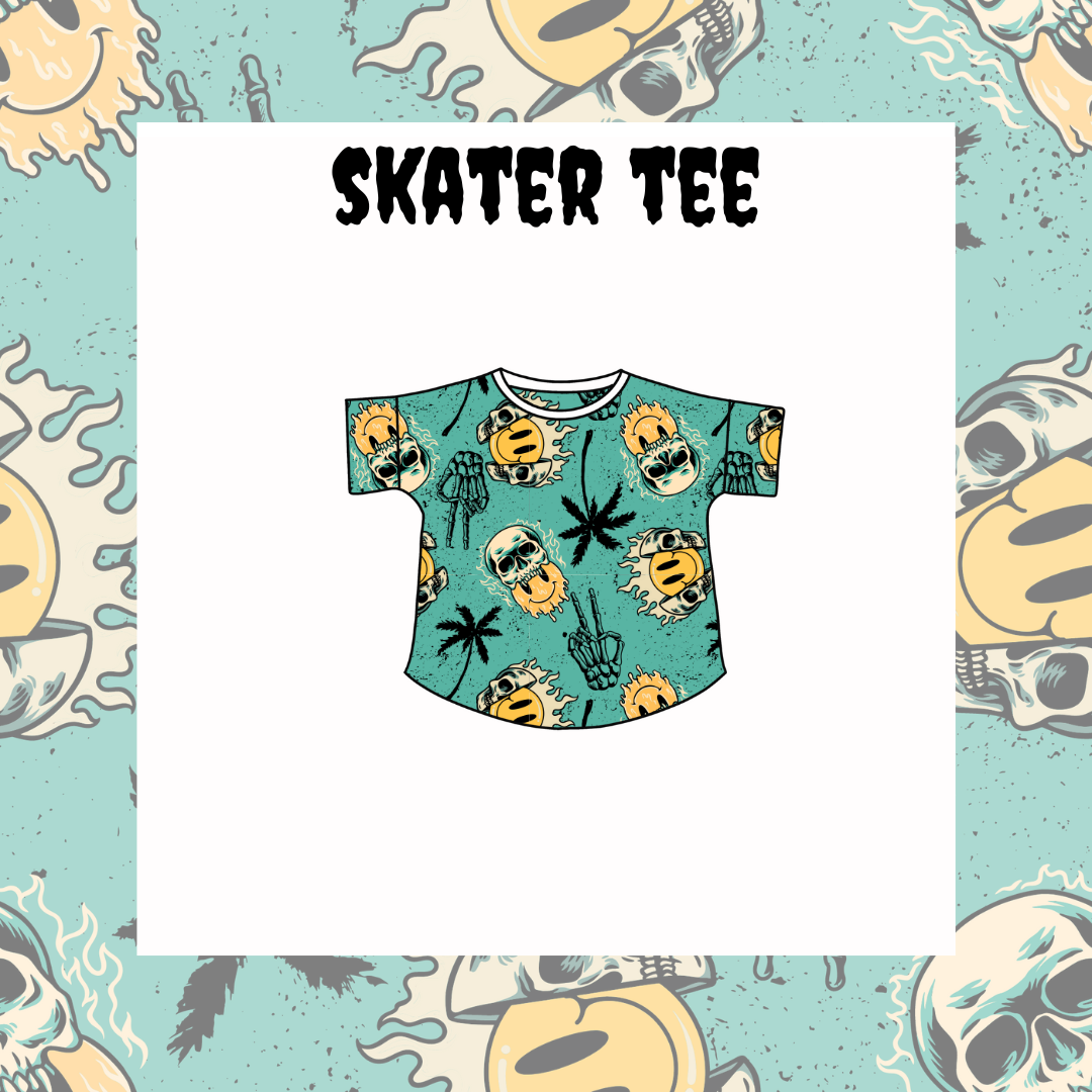A graphic tee with a multicolored skull, pineapple, and cactus pattern on a light blue background, labeled 'SKATER TEE'.