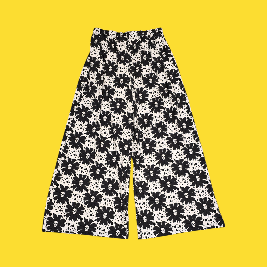 Black floral patterned pants on a yellow background