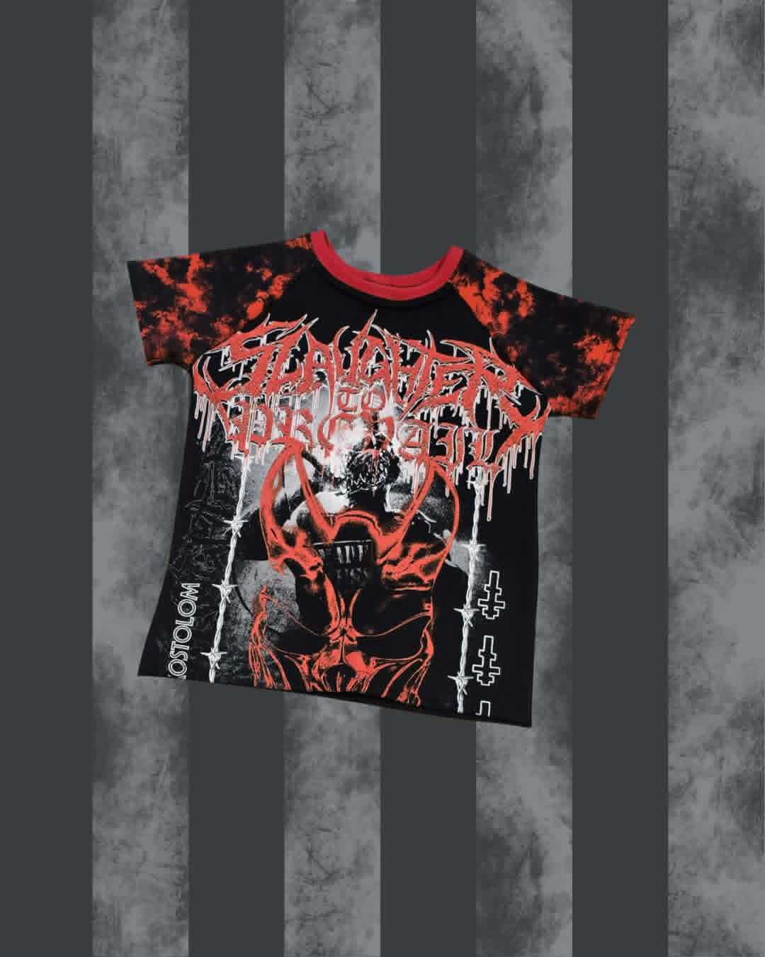 A black short-sleeve graphic SLAUGHTER TO PREVAIL t-shirt with a red crew neck, featuring a red and white horror-themed band logo and illustration, displayed against a gray and black striped background.