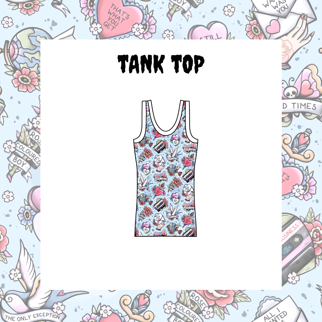 A white tank top with a colorful retro tattoo-style graphic print featuring skulls, roses, and hearts, shown on a white card centered within a decorative tattoo-themed border. The text 'TANK TOP' is printed above the garment.