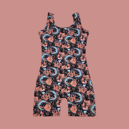 A pink and blue unitard with witchy crystals repeating pattern